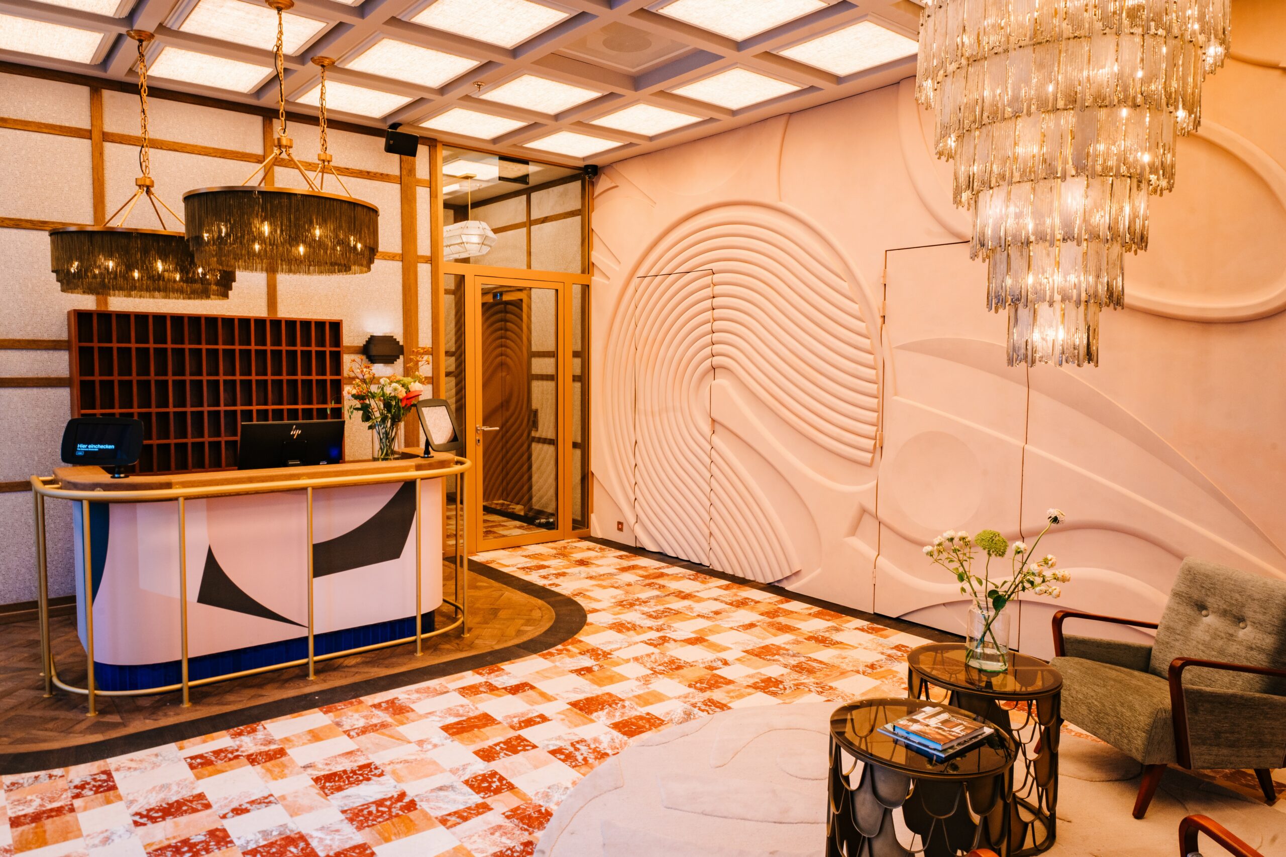 a lobby with a chandelier and a table